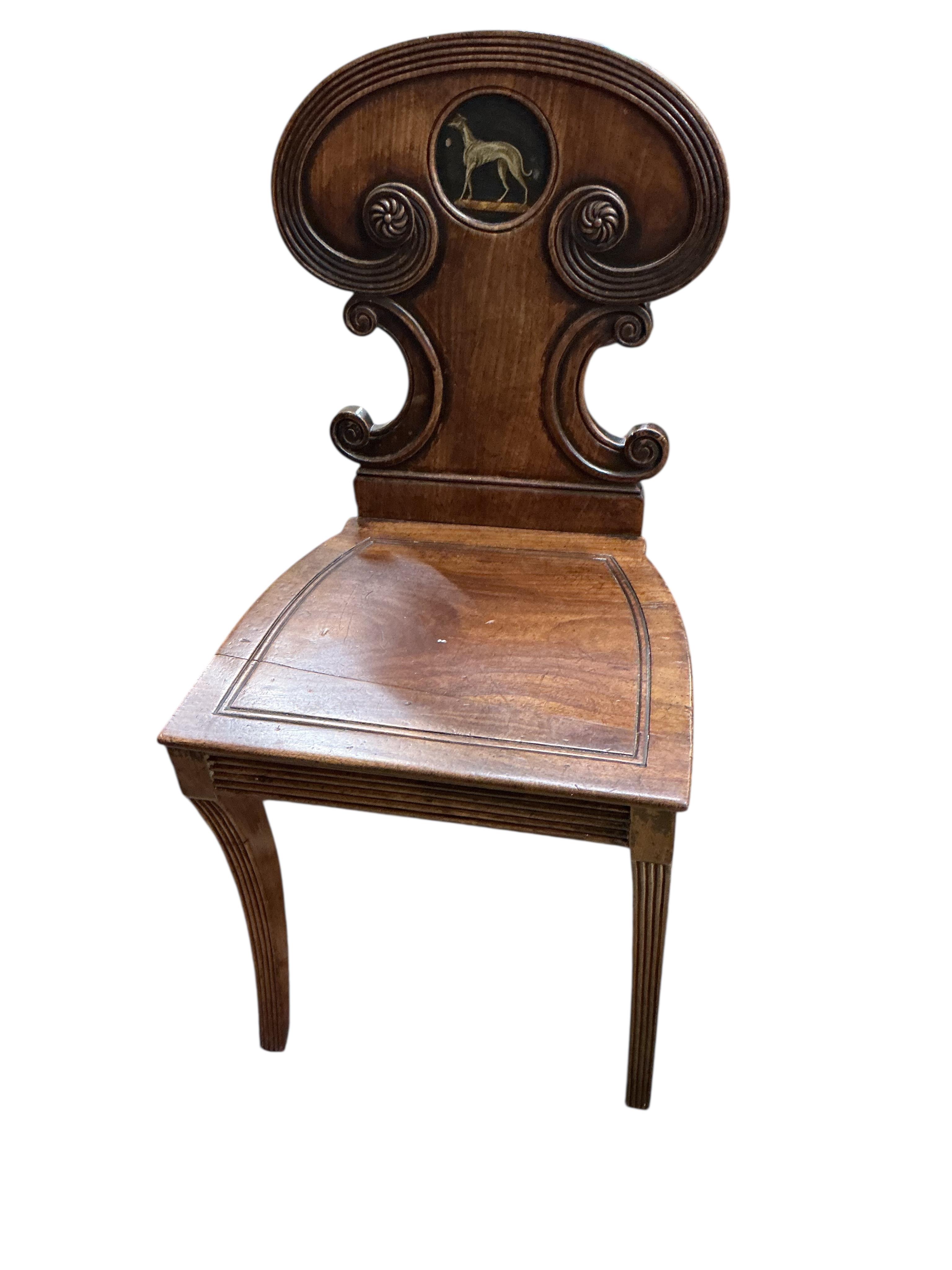 A Regency mahogany hall chair with painted greyhound armorial, height 83cm